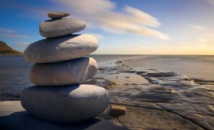 Stack of rocks balancing on a serene beach. 